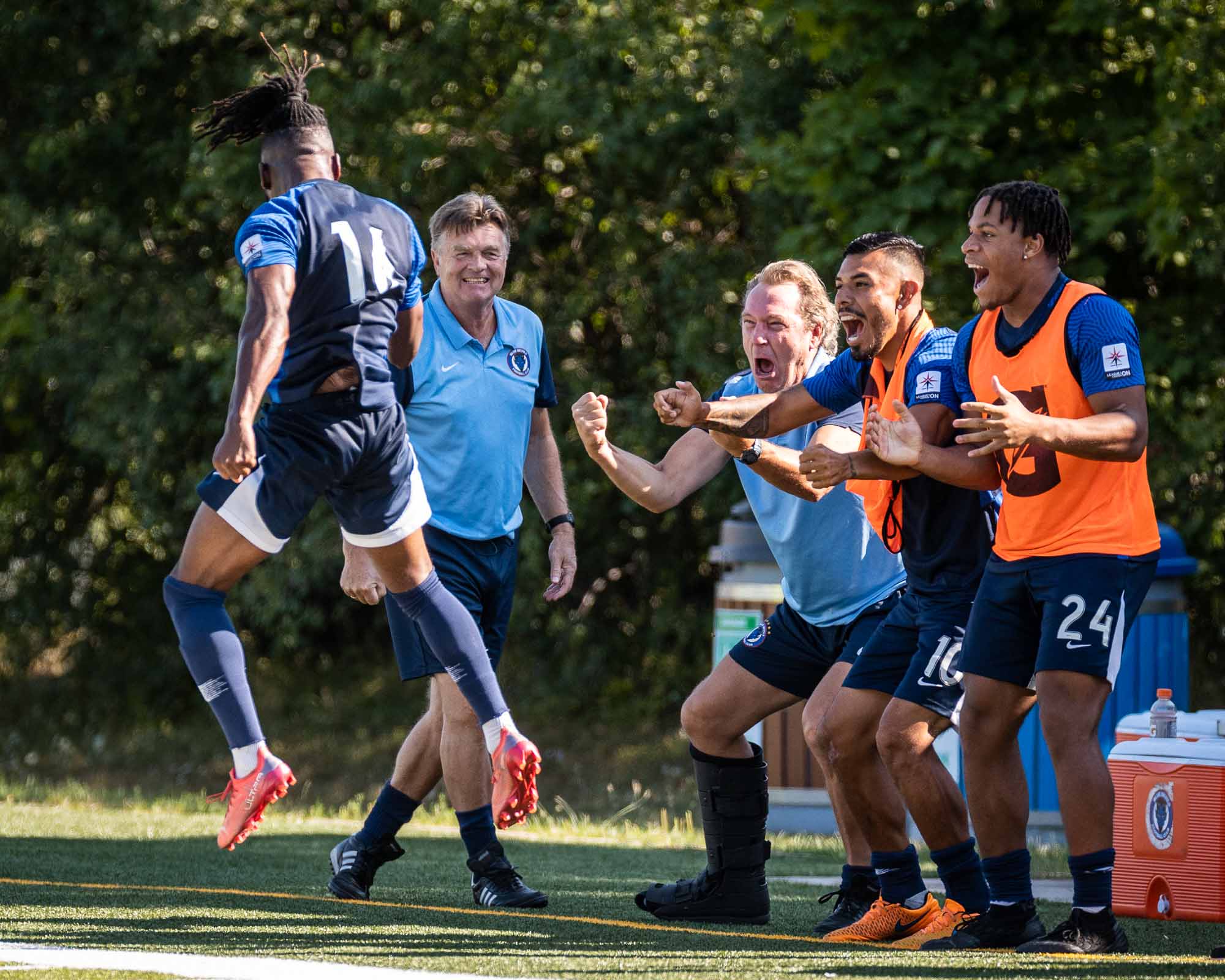 High Flyer | Khody Ellis celebrates with the bench after giving the Blue Devils the lead in the first half of play. | Kevin Raposo